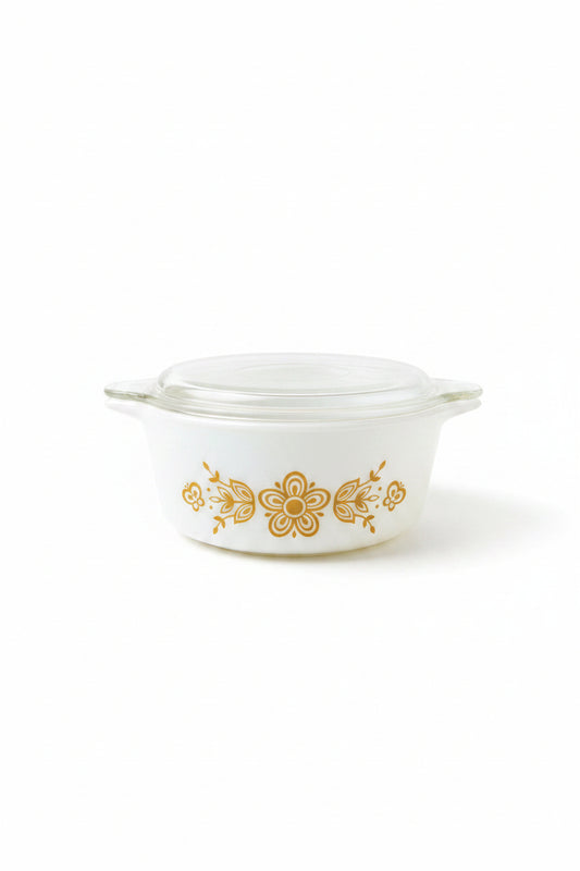 White Pyrex dish with floral design on a textured surface