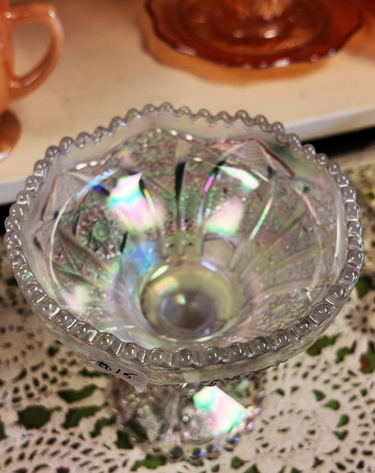 Iridescent glass candy dish on a lace tablecloth