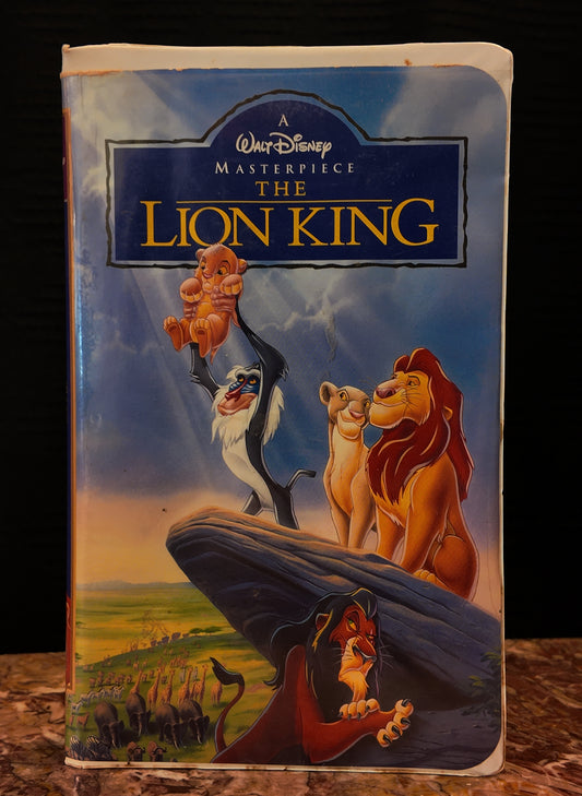 VHS tape cover of 'The Lion King' with characters on a rocky outcrop.