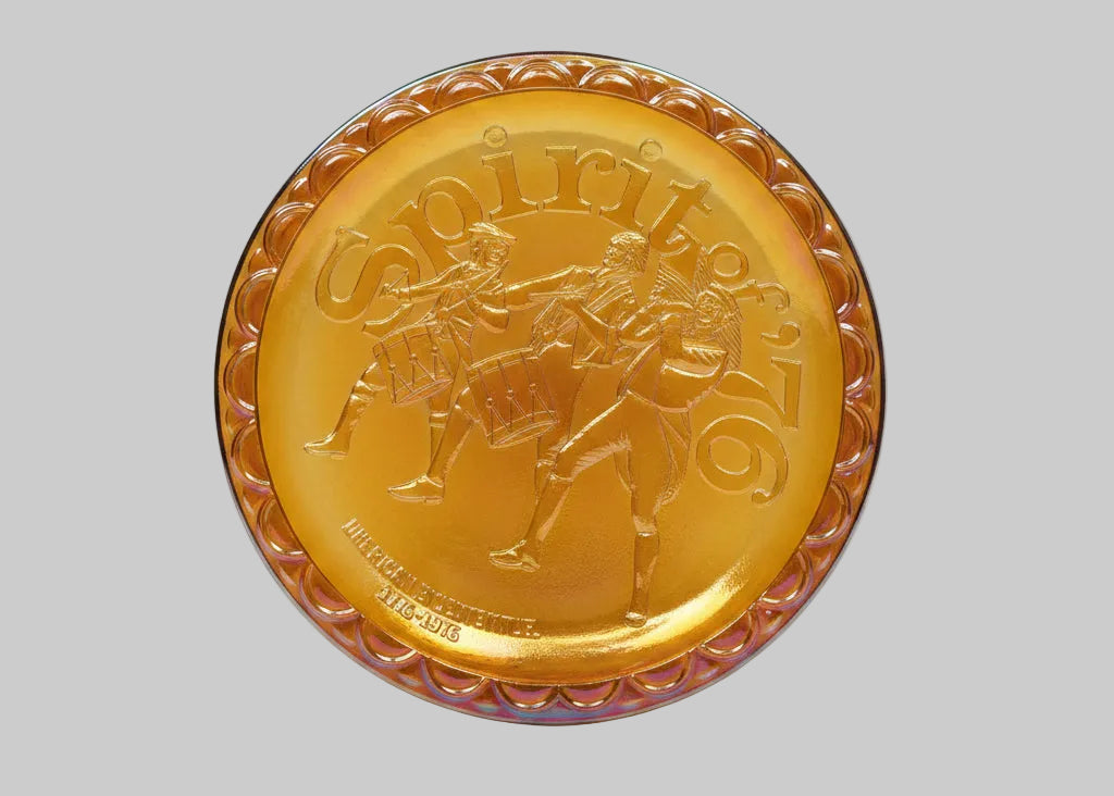 Gold-colored decorative plate with a horse and rider design on a white background