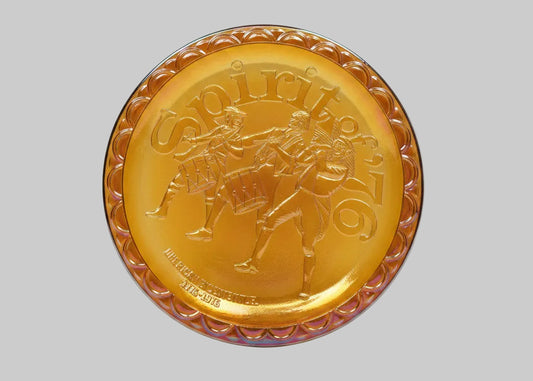 Gold-colored decorative plate with a horse and rider design on a white background